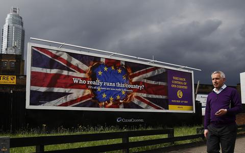 A pedestrian passes a United Kingdom Independence Party European elections campaign poster in Vauxhall, central London