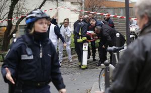 Firefighters carry a victim on a stretcher at the scene after a shooting at the Paris offices of Charlie Hebdo, a satirical newspaper,