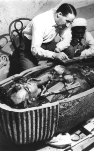 Howard Carter, English archaeologist, examining the opened sarcophagus of King Tut