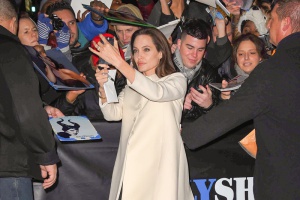 Actress Angelina Jolie is all smiles while taking selfies with the crowd outside 'The Daily Show with Jon Stewart' in New York City.