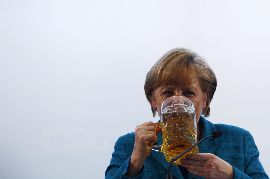 German Chancellor and head of the Christian Democratic Union (CDU) Angela Merkel drinks a beer after her speech in a beer tent in Munich. (Michaela Rehle/Reuters photo)