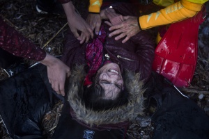 A woman reacts after her arrival in bad weather from Turkey to the Greek island of Lesbos on a dinghy , Wednesday, Oct. 28, 2015. The Greek coast guard said it rescued 242 refugees or economic migrants off the eastern island of Lesbos Wednesday after the wooden boat they traveled in capsized, leaving at least three dead on a day when another 8 people drowned trying to reach Greece. (AP Photo/Santi Palacios)