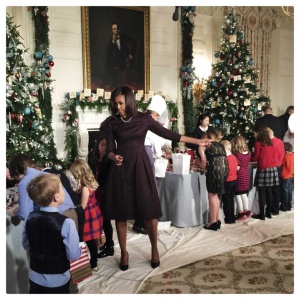 U.S. first lady Michelle Obama decorates holiday crafts with military children at the State Dining Room of the White House. The first lady hosted military families to preview the holiday decorations,  which are themed  'A Children's Winter Wonderland' this year.