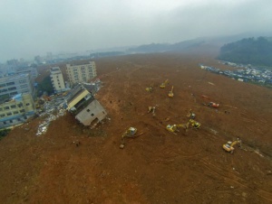 In this aerial view from a drone, Chinese rescuers search for survivors on the debris at the site of the landslide, which hit the Hengtaiyu, Liuxi and Dejicheng industrial parks, in Hongao village, Shenzhen city, south China's Guangdong province, 21 December 2015. Thousands of rescuers combed through rubble and debris on Monday (21 December 2015) as the search went on for dozens of people still missing after Sunday's landslide in the south Chinese city of Shenzhen. More than 30 buildings in an industrial park in the Guangming district of the city were engulfed when a huge pile of construction waste collapsed about 11:40am on Sunday. About 900 people were evacuated to temporary settlements, but at least 16, including a 7-year-old child, needed hospital treatment. All were said to be in a stable condition on Monday. Local authorities said 85 people were missing as of Monday night. Just seven have so far been rescued. The landslide covered an area of 380,000 square meters in 10 meters of silt, said Liu Qingsheng, deputy mayor of Shenzhen.
