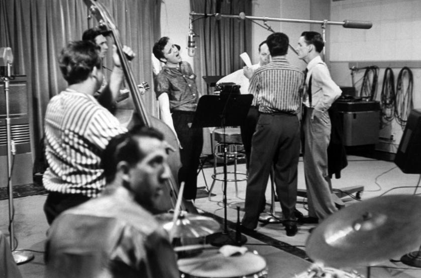 Elvis Presley recording a new song in an unident. recording studio, backed up by the Jordanaires vocally (made up of Gordon Stoker, Neal Matthews, Jr., Hoyt Hawkins and Hugh Jarrett), Bill Black on bass and D.J. Fontana on drums.  (Photo by Don Cravens/The LIFE Images Collection/Getty Images)