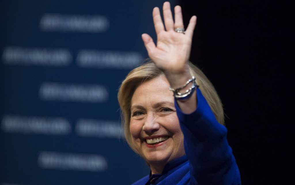 Former U.S. Secretary of State Hillary Rodham Clinton waves to the audience during a book launch in Berlin, Germany, Sunday, July 6, 2014. The former Secretary of State   is on a tour promoting her new book, "Hard Choices." The German titel of the book is "Entscheidungen". (AP Photo/Gero Breloer)