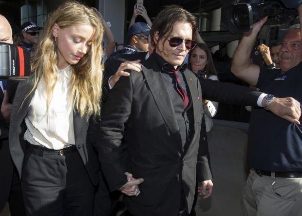 Amber Heard and her husband Johnny Depp pictured as they leave Southport Magistrates Court after attending their hearing in which they pleaded guilty to the charges of falsifying a quarantine document.Pictured: AMBER HEARD, JOHNNY DEPPRef: SPL126