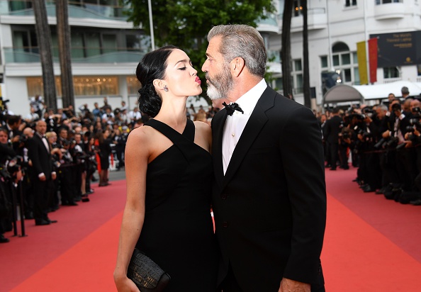 US actor Mel Gibson and his partner Rosalind Ross pose as they arrive on May 22, 2016 for the closing ceremony of the 69th Cannes Film Festival in Cannes, southern France.  / AFP / ANNE-CHRISTINE POUJOULAT        (Photo credit should read ANNE-CHRISTINE POUJOULAT/AFP/Getty Images)