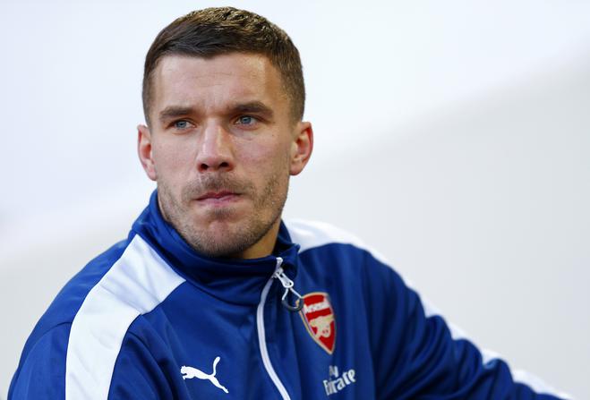 LONDON, ENGLAND - DECEMBER 28: Lukas Podolski of Arsenal takes his seat on the bench before the Barclays Premier League match between West Ham United and Arsenal at Boleyn Ground on December 28, 2014 in London, England. (Photo by Julian Finney/Getty Images)