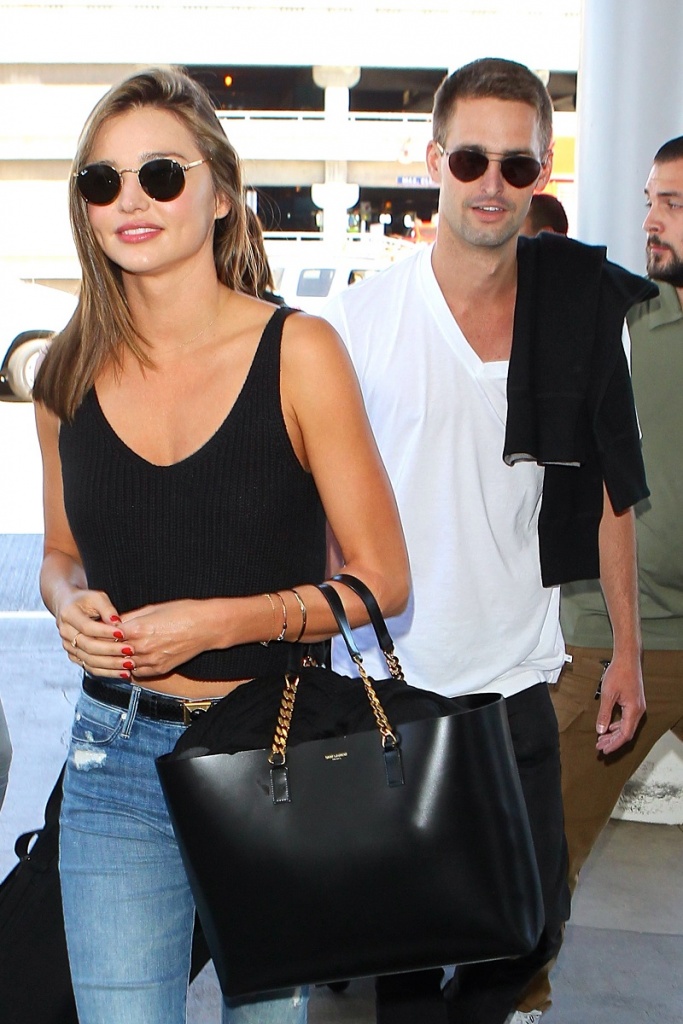 UK CLIENTS MUST CREDIT: AKM-GSI ONLY Los Angeles, CA - Miranda Kerr and her new boyfriend Evan Spiegel smile ear to ear in front of the cameras as they arrive at LAX for a flight out of town together. The good looking couple held each other in the check out line and laughed along the way to the security gates together. Pictured: Miranda Kerr Evan Spiegel Ref: SPL1101415 120815 Picture by: AKM-GSI / Splash News 