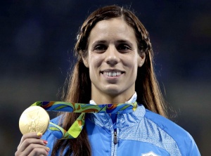 Greece's Ekaterini Stefanidi holds her gold medal for the women's pole vault event during an athletics medals ceremony at the Summer Olympics at Olympic stadium in Rio de Janeiro, Brazil, Saturday, Aug. 20, 2016. (AP Photo/Jae C. Hong)
