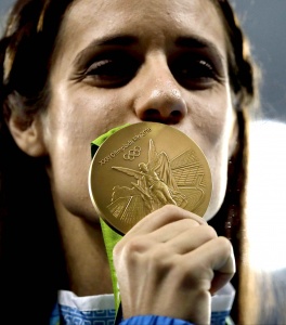 Greece's Ekaterini Stefanidi kisses her gold medal for the women's pole vault event during an athletics medals ceremony at the Summer Olympics at Olympic stadium in Rio de Janeiro, Brazil, Saturday, Aug. 20, 2016. (AP Photo/Jae C. Hong)