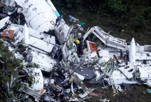 Rescue crew work at the wreckage from a plane that crashed into Colombian jungle with Brazilian soccer team Chapecoense near Medellin