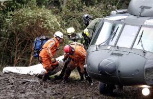 A Colombian air force helicopter retrieves bodies of victims from the wreckage of a plane that crashed into the Colombian jungle with Brazilian soccer team Chapecoense onboard, near Medellin