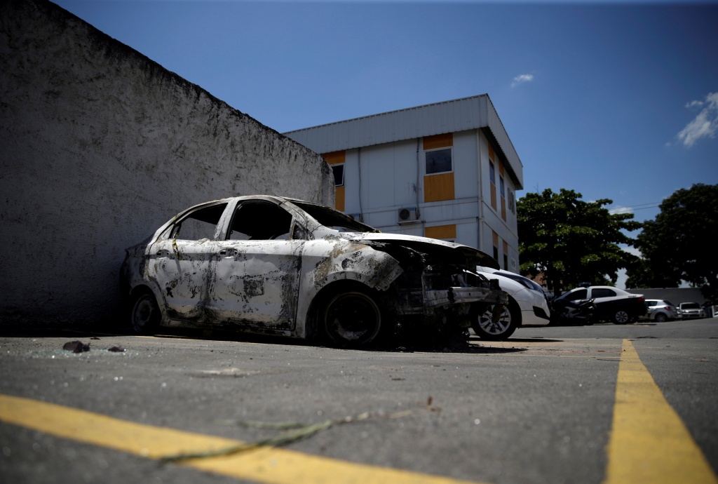 A burnt car in which a body was found during searches for the Greek Ambassador for Brazil Kyriakos Amiridis, is pictured at a police station in Belford Roxo
