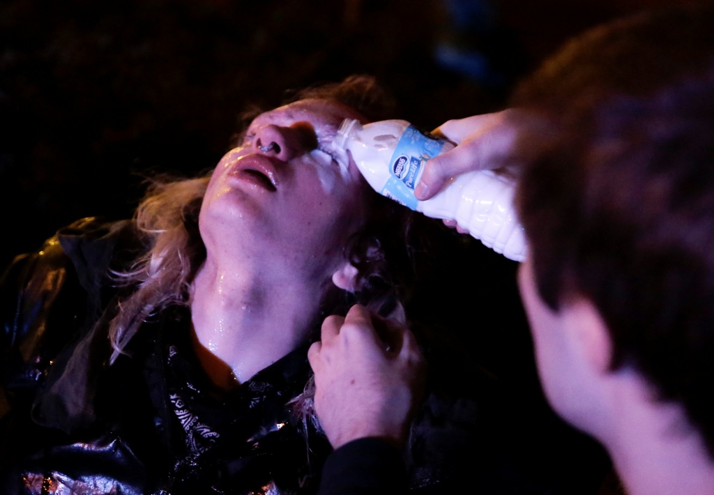 A protester is treated after being pepper sprayed by police at the University of Washington where protesters arrived outside a speaking engagement by Breitbart News editor Milo Yiannopoulosin in Seattle, Washington