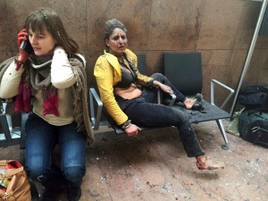 PLEASE HOLD FOR UPCOMING STORIES - In this file photo provided by photographer Ketevan Kardava, Nidhi Chaphekar, a 40-year-old Jet Airways flight attendant from Mumbai, right, and another unidentified woman are shown after being wounded in Brussels Airport in Brussels, Belgium, after explosions rocked the airport on March 22, 2016. (Ketevan Kardava via AP, File)