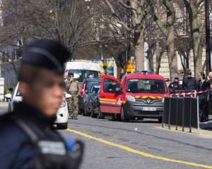 French police officers take position after letter bomb exploded at the French office of the International Monetary Fund, lightly injuring one person, Thursday, March 16, 2017. A police official said no other damage was been reported in the incident. (AP Photo/Thibault Camus)