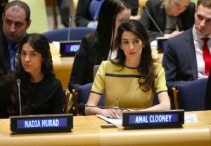 Human rights lawyer Amal Clooney, right, and her client Nadia Murad, left, a human rights activist and Yazidi genocide survivor by ISIS listen during a United Nations human rights meeting called “The Fight against Impunity for Atrocities: Bringing Da’esh [ISIS] to Justice," Thursday, March 9, 2017 at U.N. headquarters. (AP Photo/Bebeto Matthews)