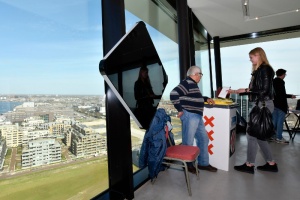 People casts their vote for the Dutch general election in a polling station on the twentieth floor of The A'dam Tower in Amsterdam, Netherlands, Wednesday, March 15, 2017. (AP Photo/Patrick Post)